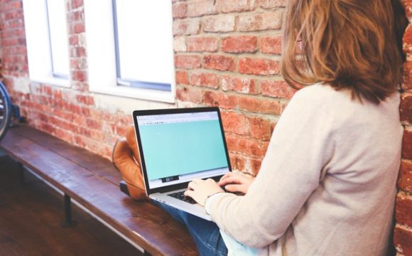 Woman Typing Blogs at Start Up