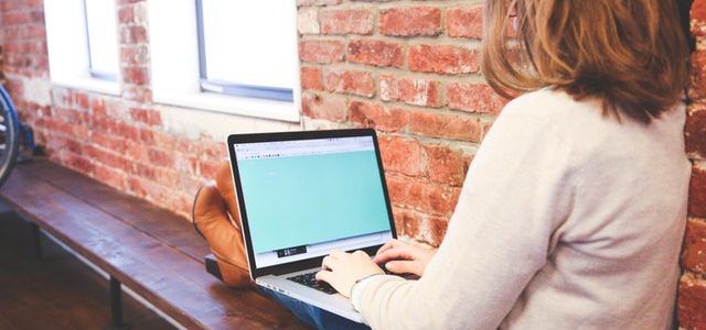 Woman Typing Blogs at Start Up