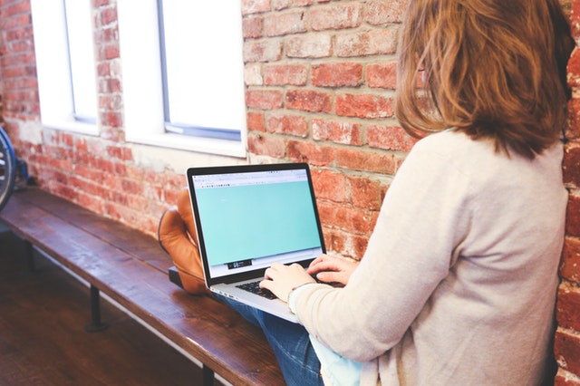 Woman Typing Blogs at Start Up