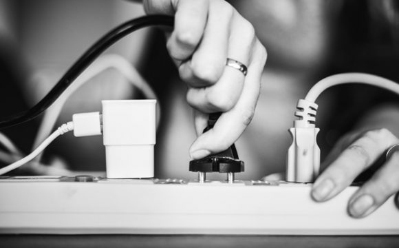 woman plugging in a power cord