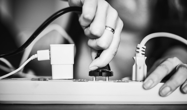 woman plugging in a power cord