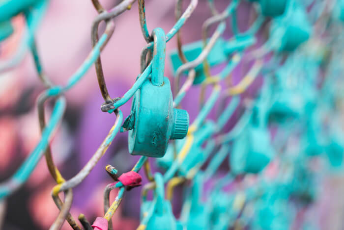 Security concept with lock on a fence